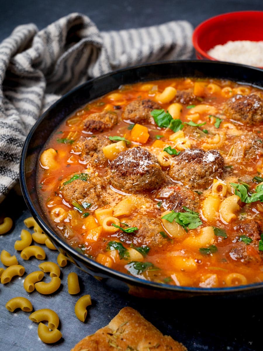 A bowl of Italian soup with meatballs