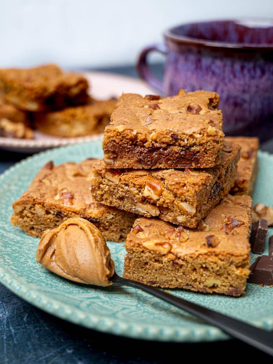 A plate of blondies with a spoon of Biscoff spread
