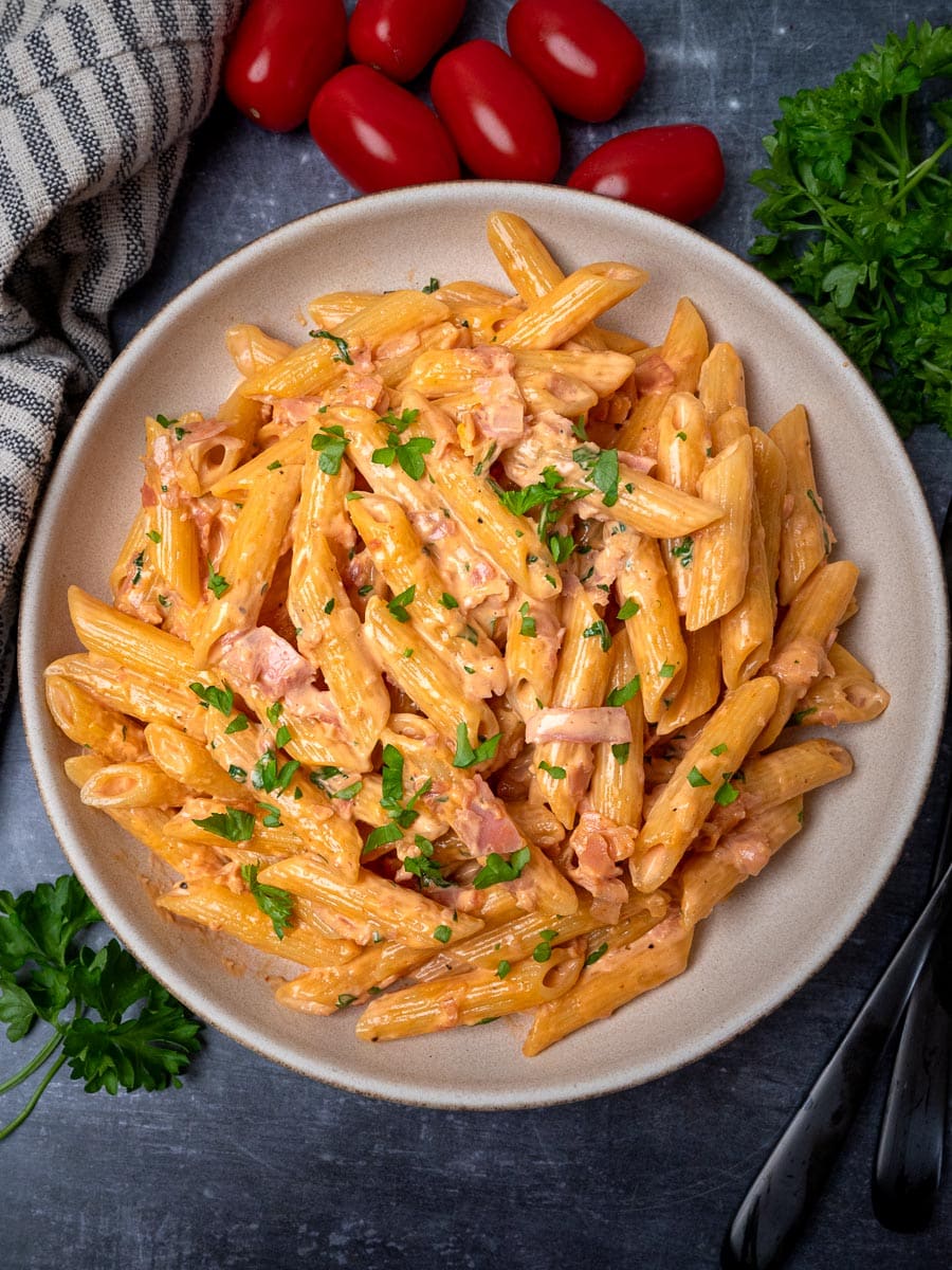 A bowl of pasta with creamy ham sauce