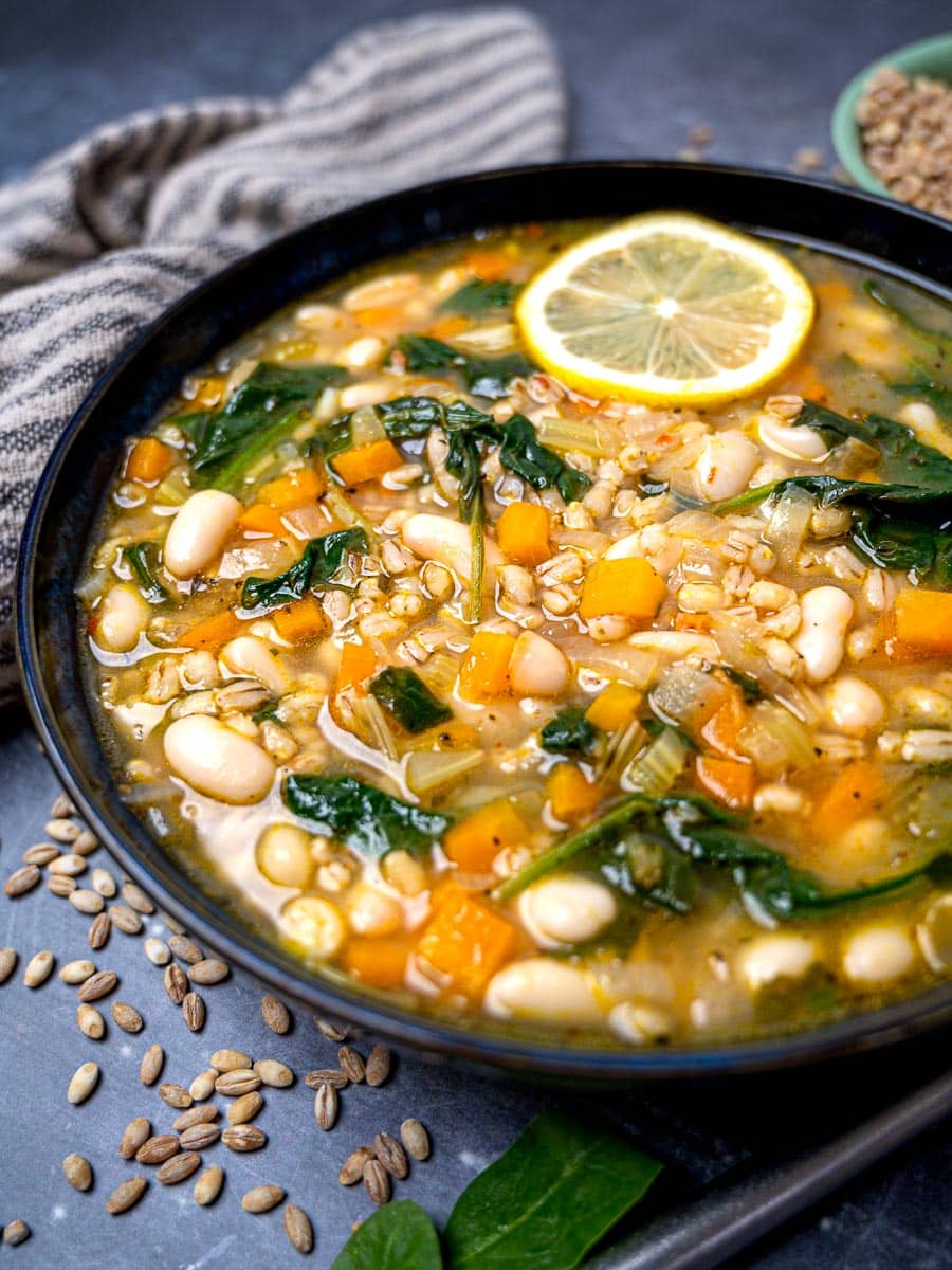 A bowl of barley soup with vegetables