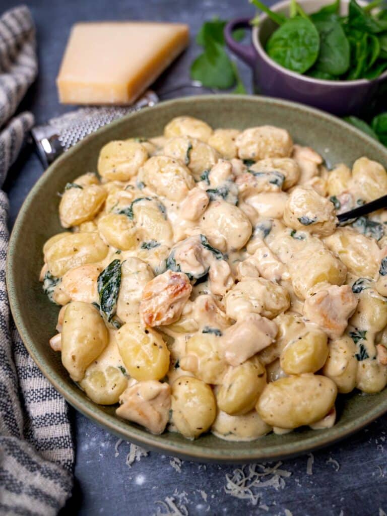 A bowl of gnocchi with a fork in it
