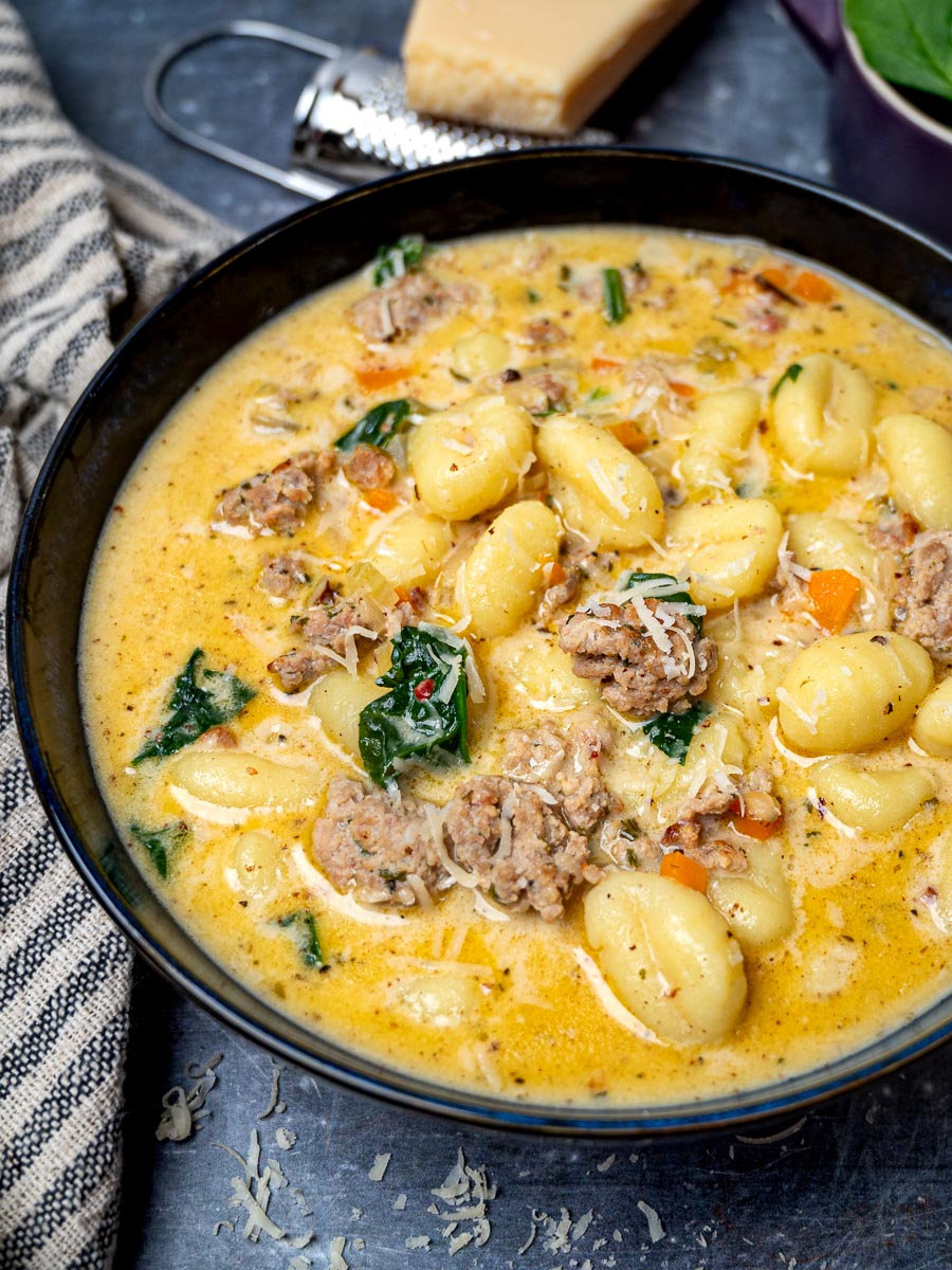 Close up photo of a bowl of gnocchi soup with sausage