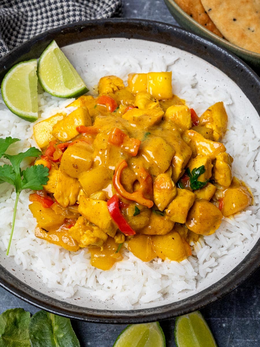 a plate of mango chicken curry