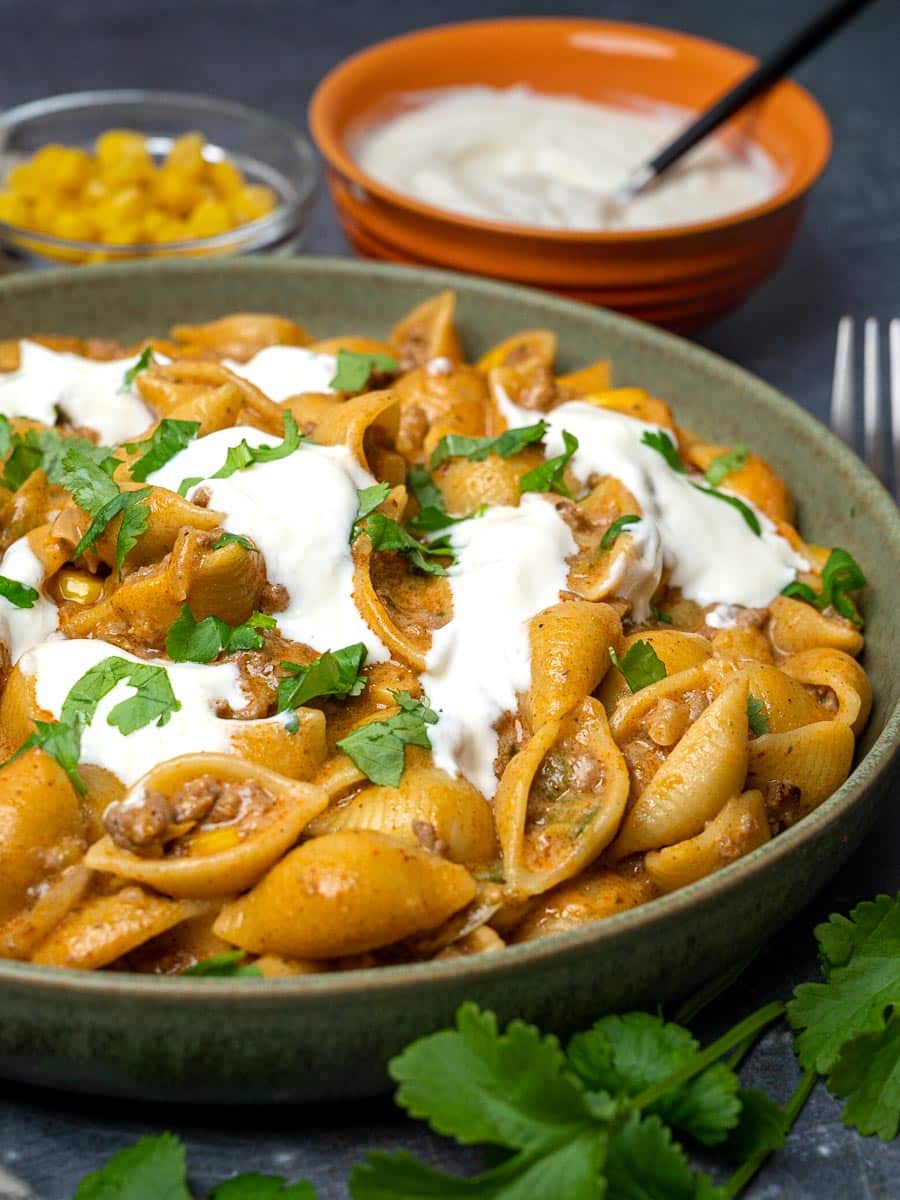 A bowl of Mexican-style pasta with sour cream on top