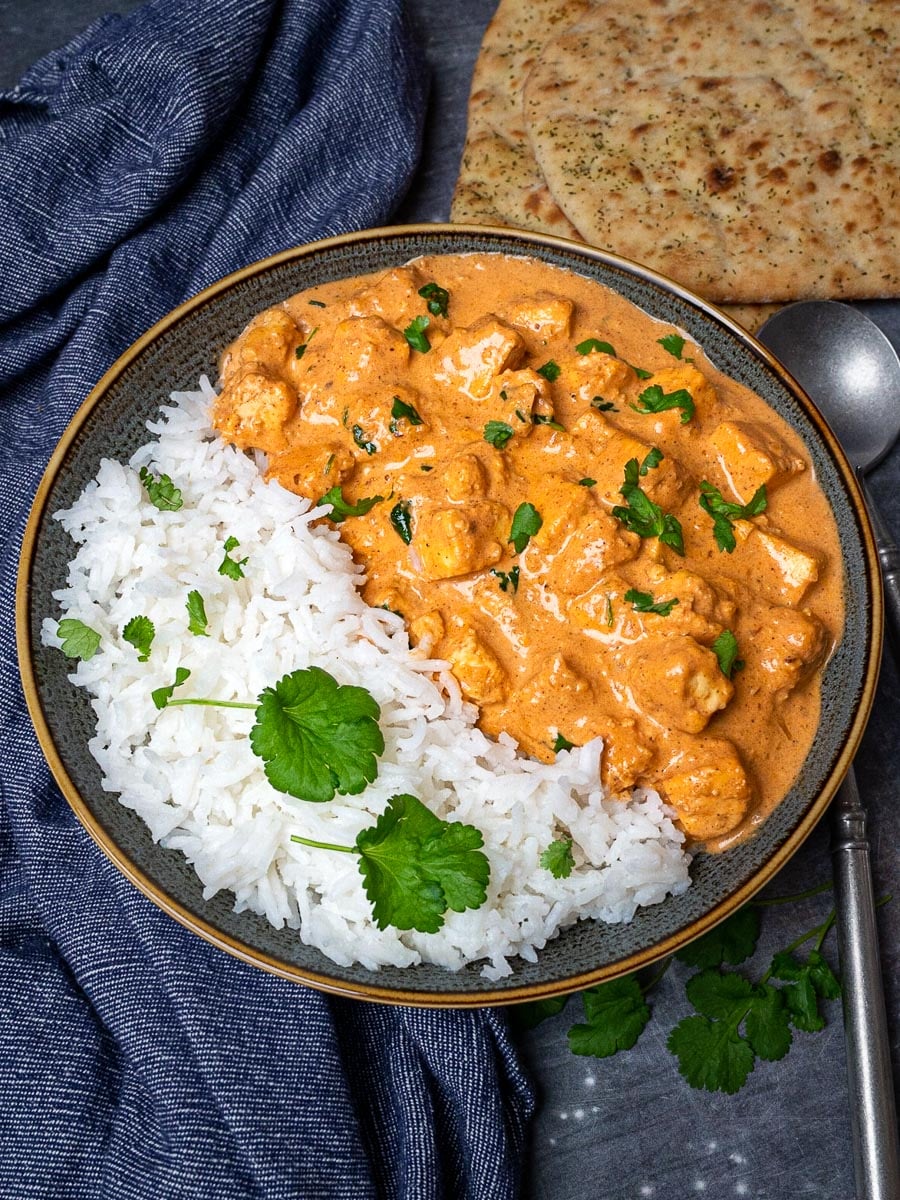 A plate of paneer butter masala with rice