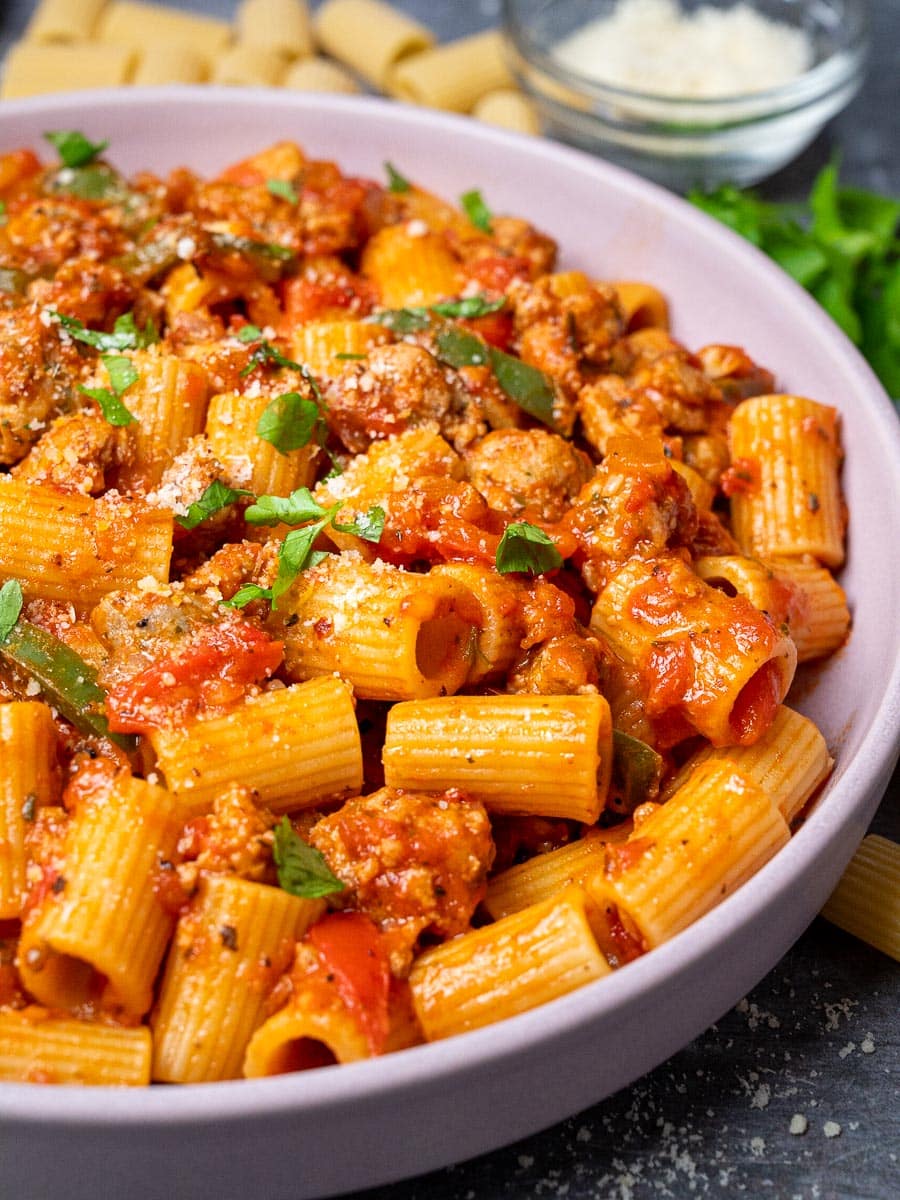 a plate of sausage and peppers pasta