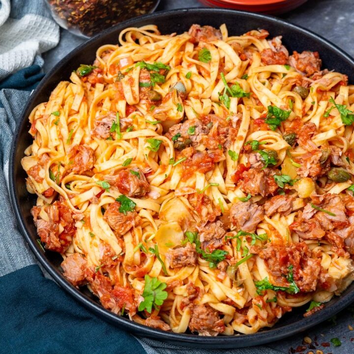 A bowl of pasta with tuna and tomatoes