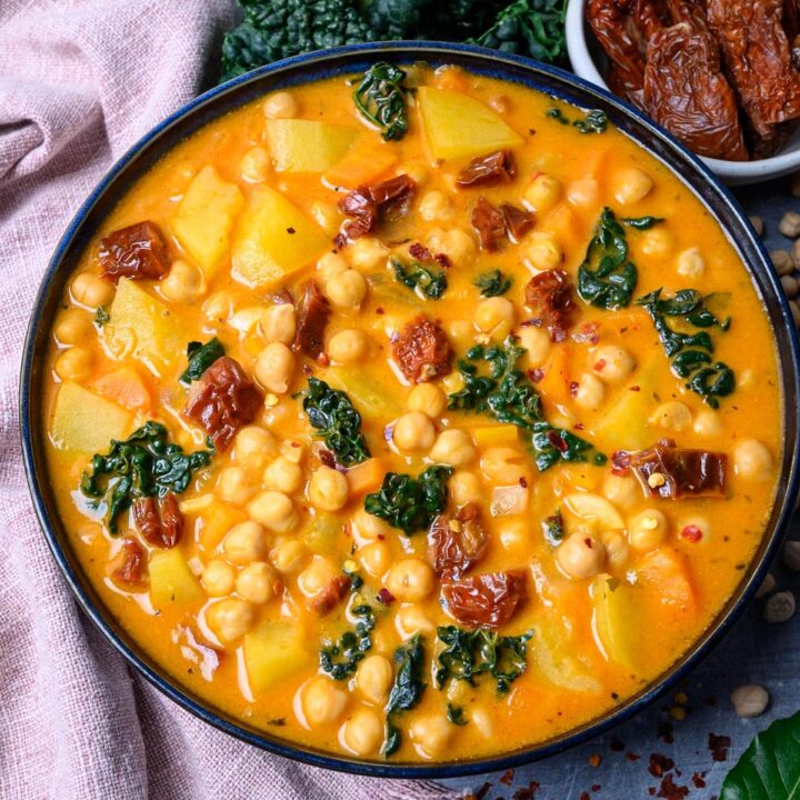 A bowl of creamy chickpea soup with sun-dried tomatoes.