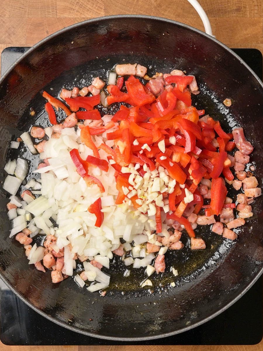 Sauteeing the pancetta, onion, peppers and garlic