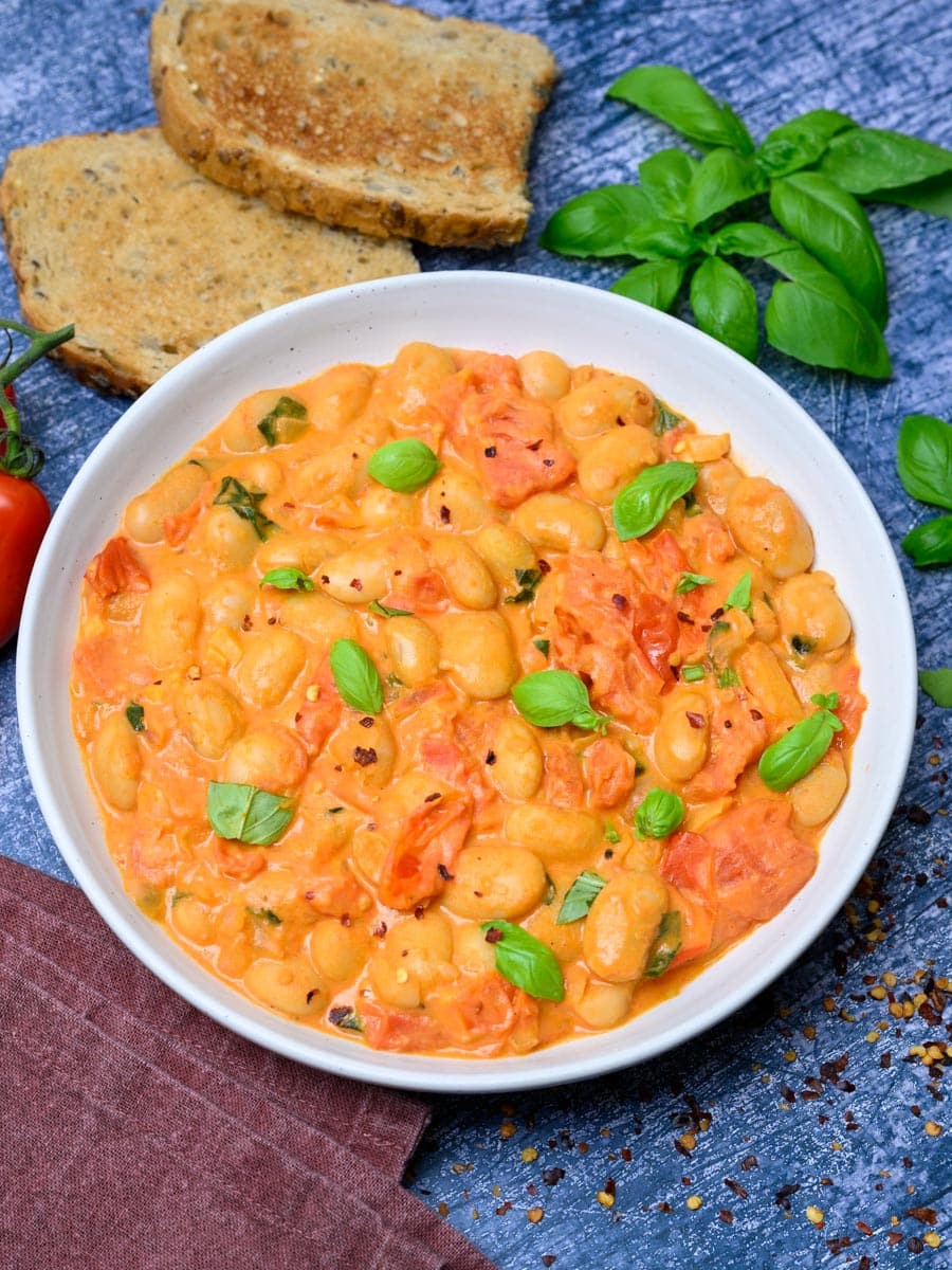 a plate of tomato basil butter beans