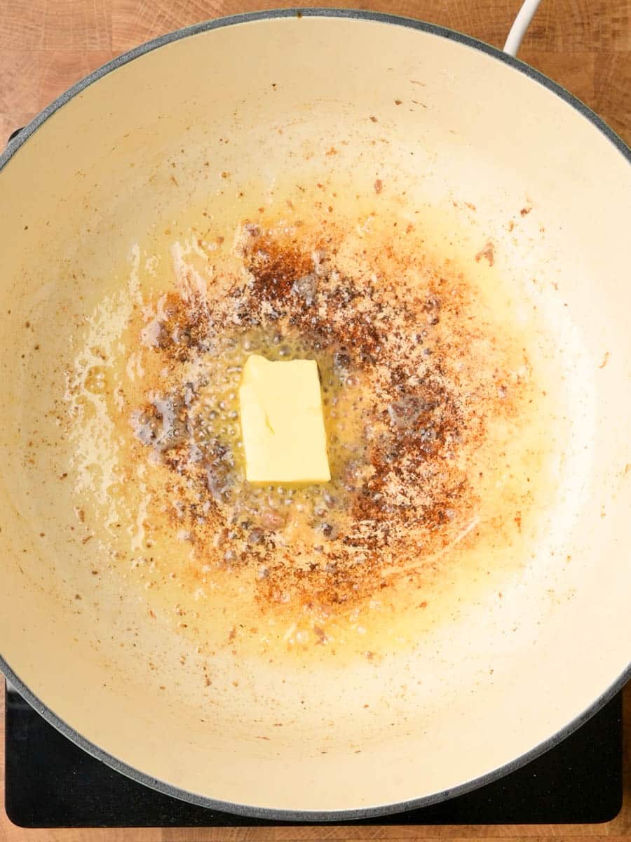 adding butter to a swedish meatball soup