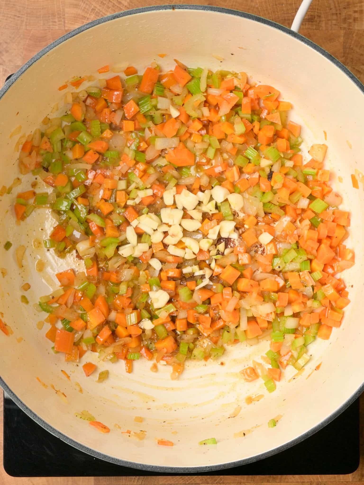 adding garlic to a swedish meatball soup