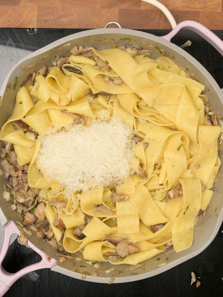 adding parmesan to an Italian dish