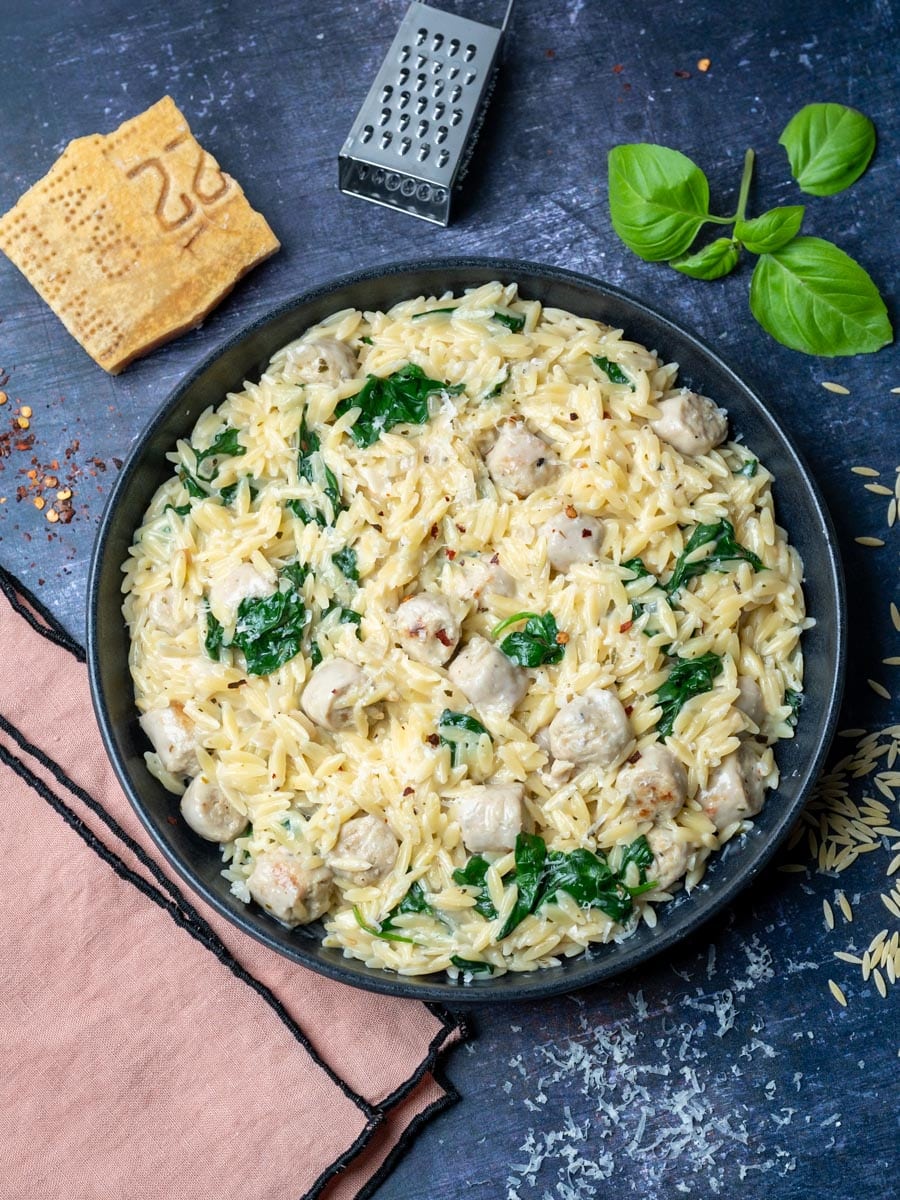 a plate of a chicken sausage orzo