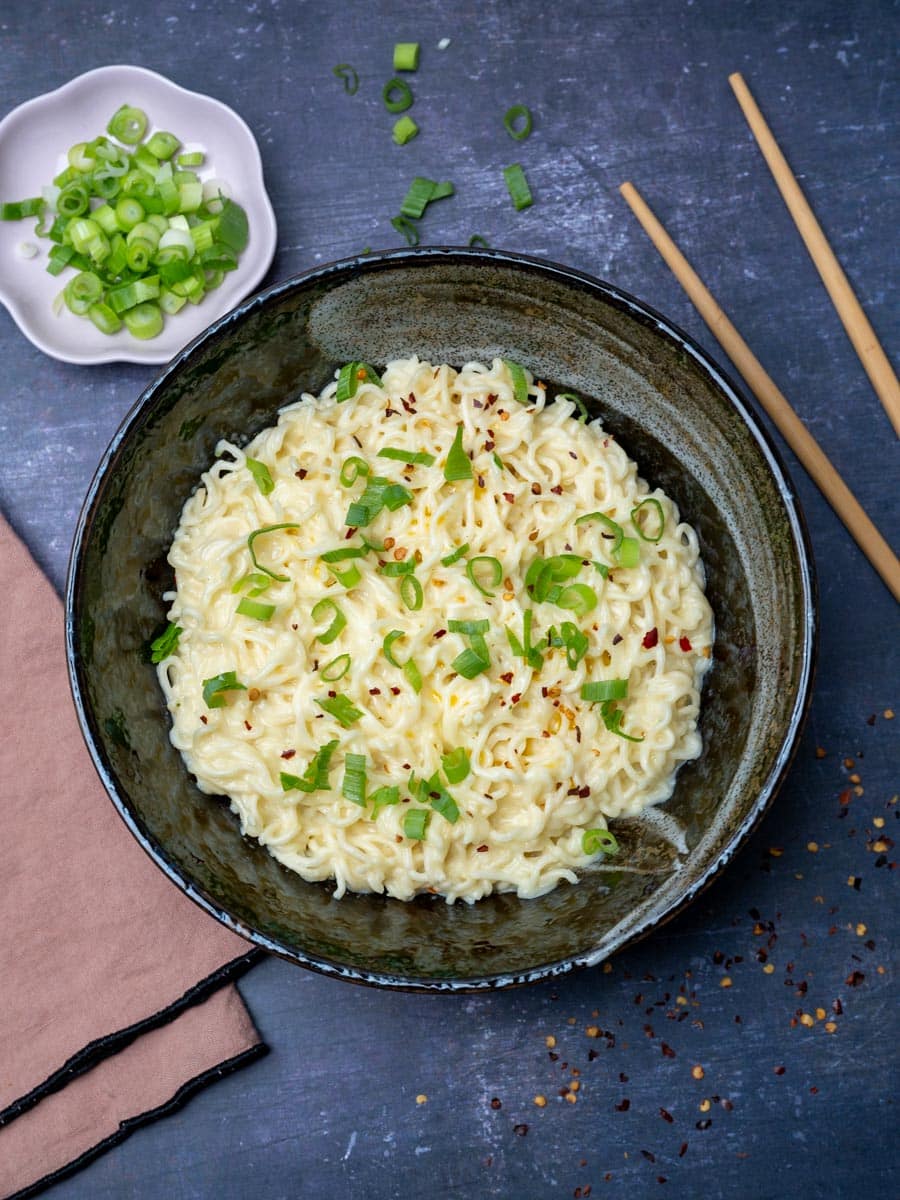 a bowl of cheesy ramen noodles