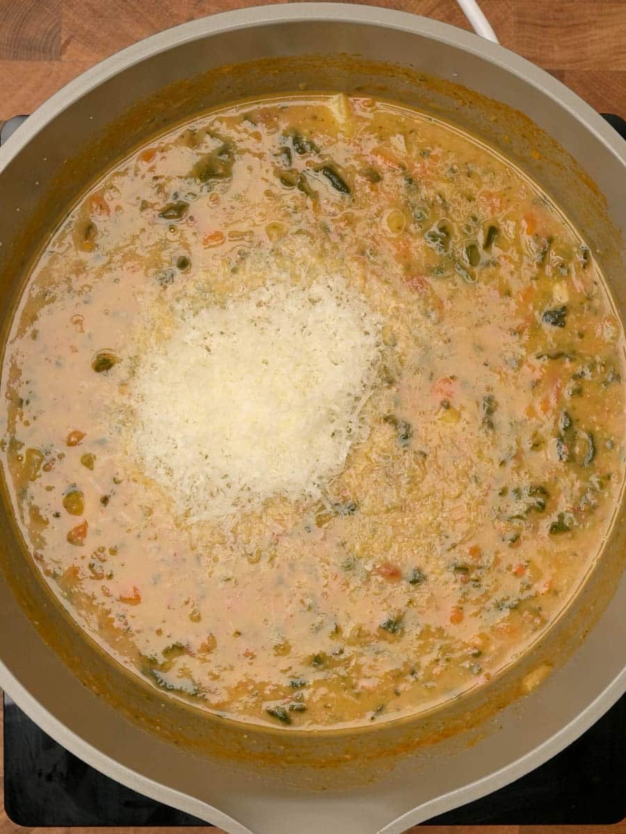 adding parmesan to an Italian dish