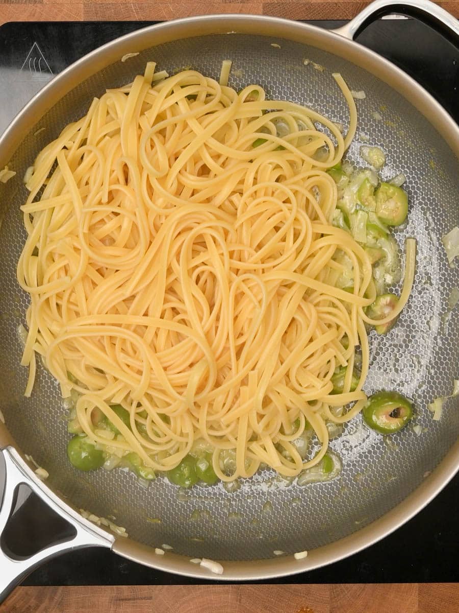 adding spaghetti to an American dish
