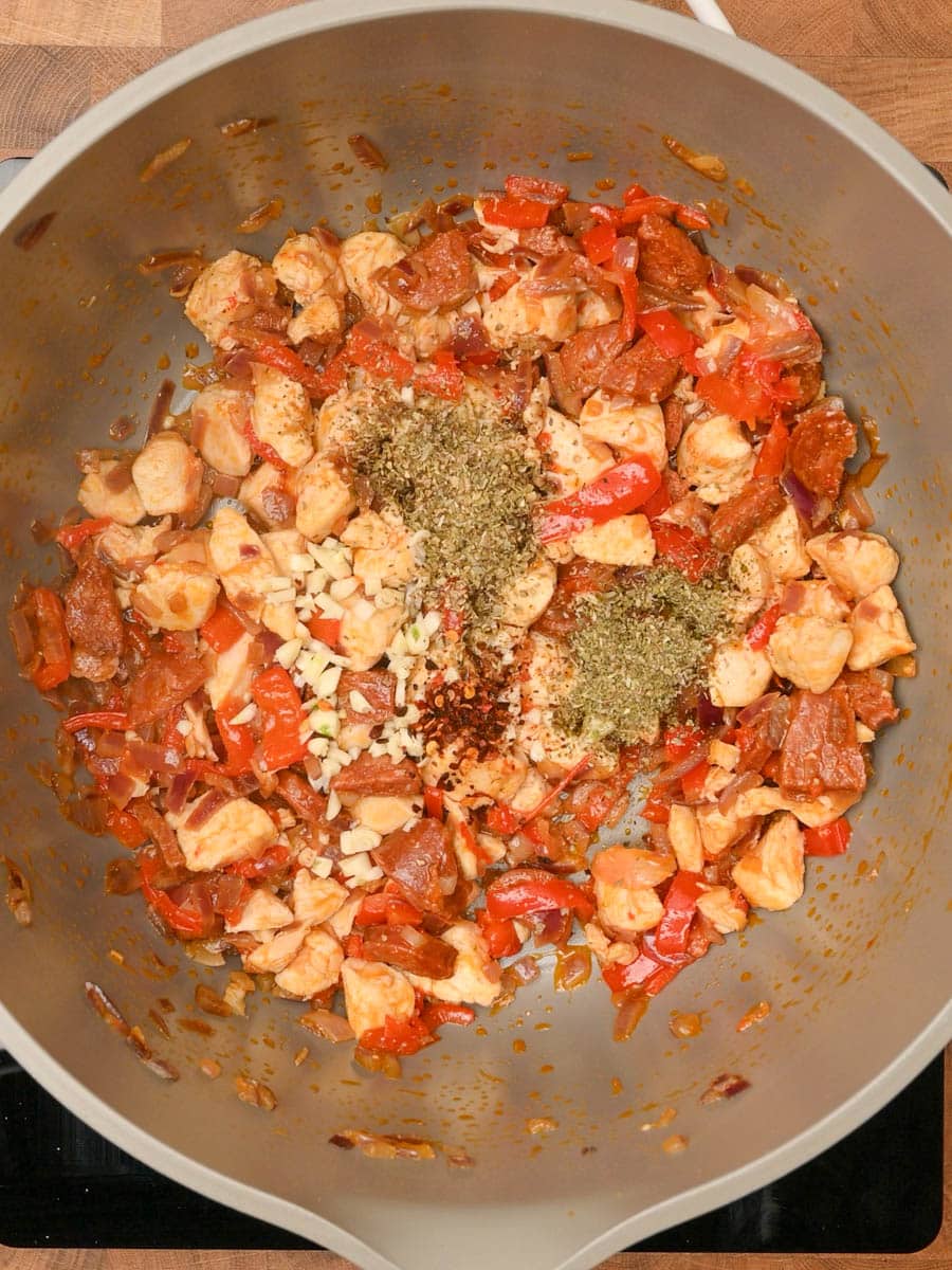 Garlic and dried herbs mixed into chicken, chorizo, and peppers.