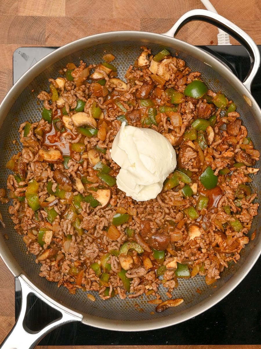 adding cream to an American dish