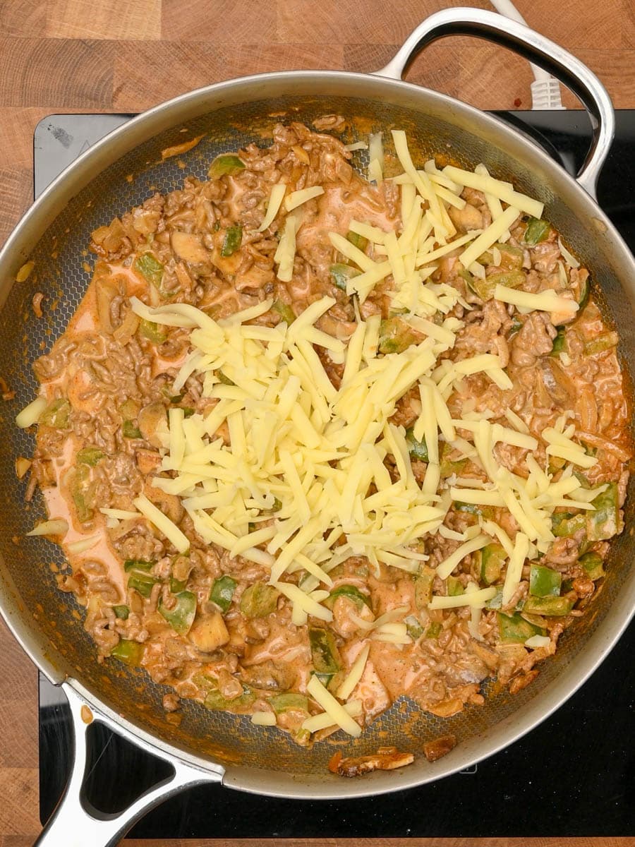 adding cheese to an American dish