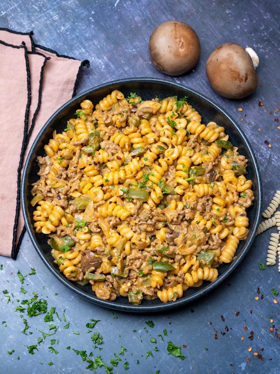 A plate of Philly cheesesteak pasta with mushrooms