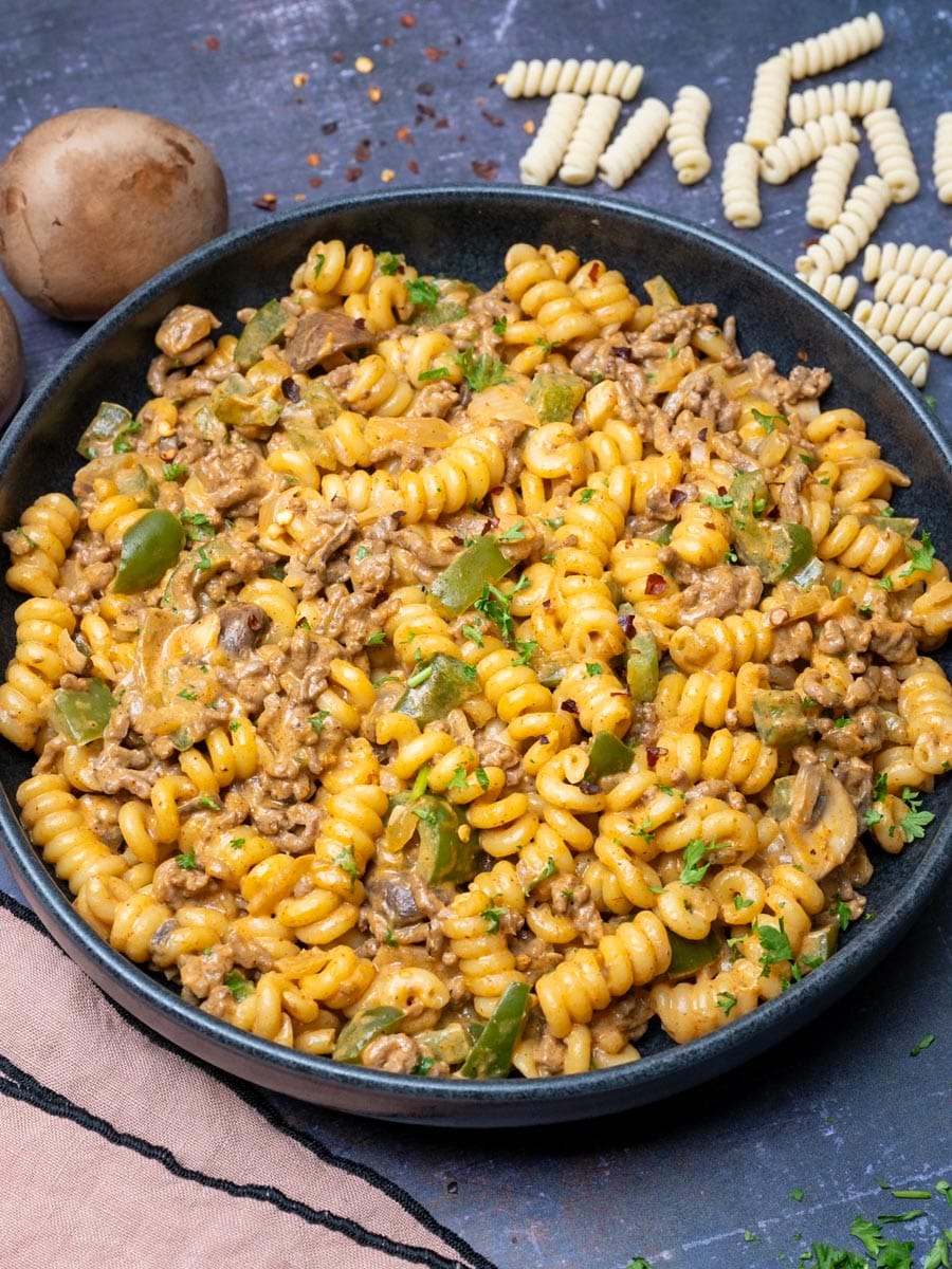 A plate of ground beef and bell peppers pasta with fusilli