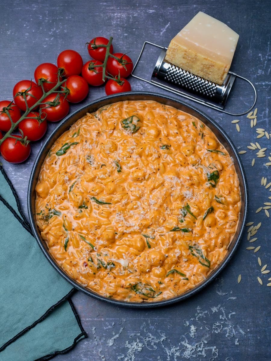 A bowl of creamy tomato orzo with parmesan