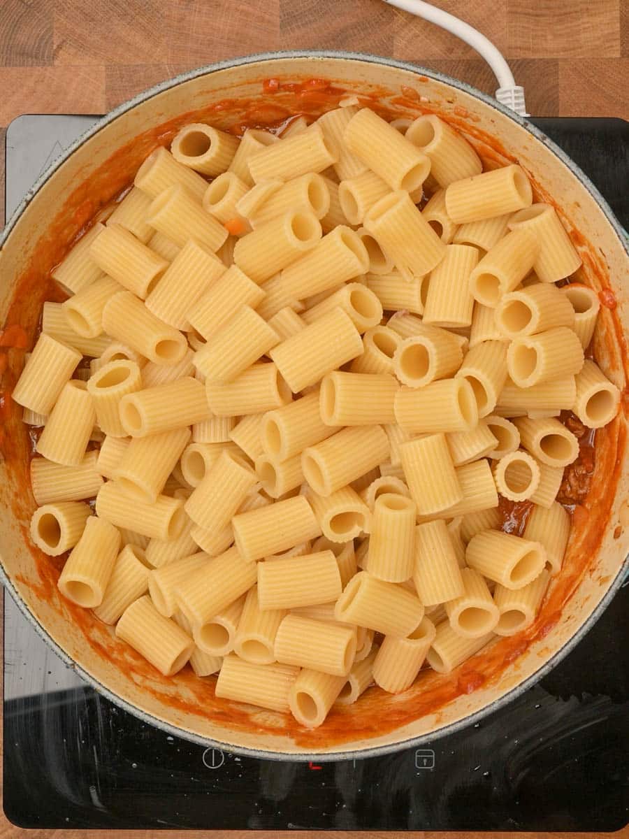 adding pasta to a British dish