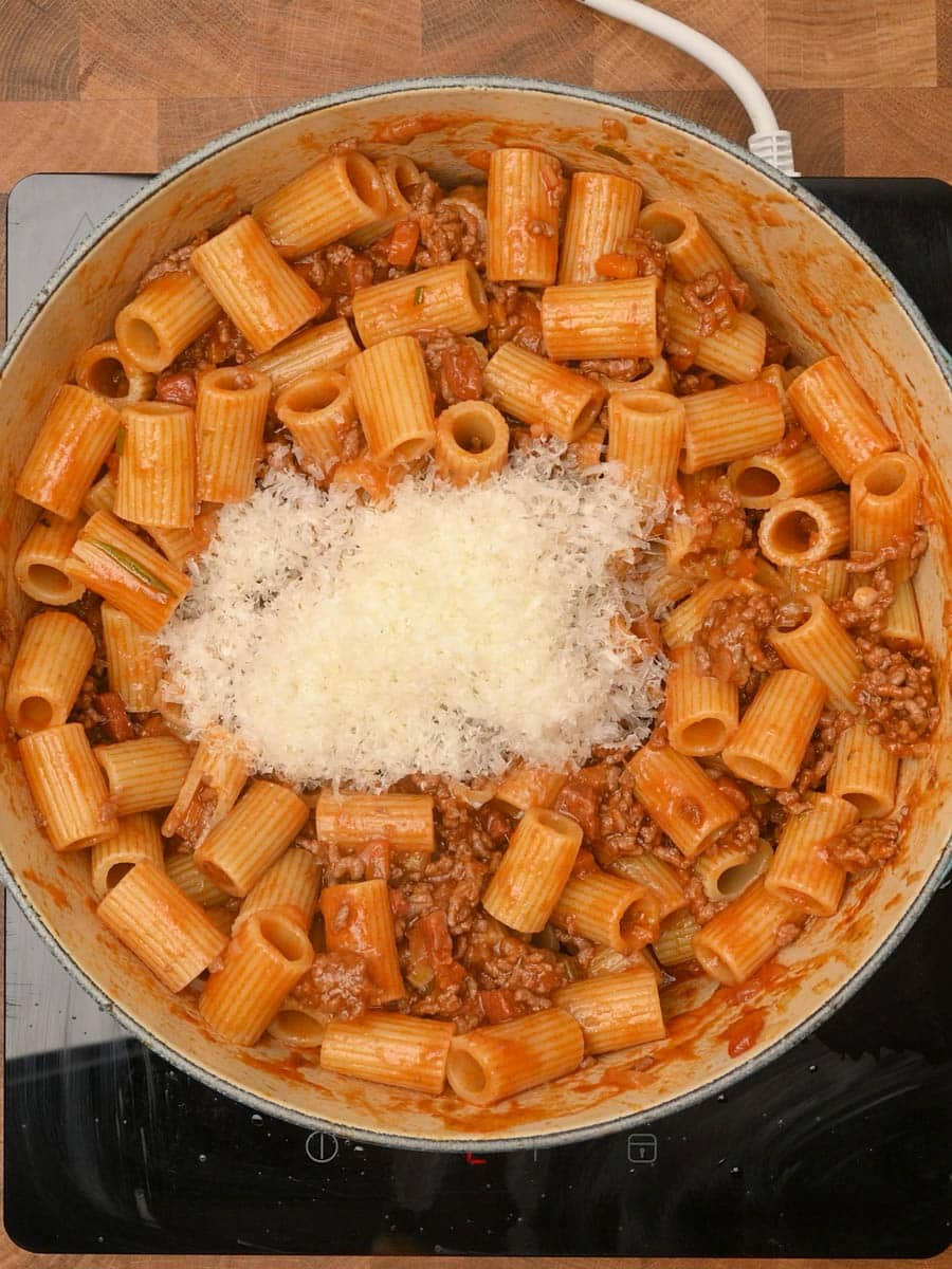adding parmesan to a pasta dish