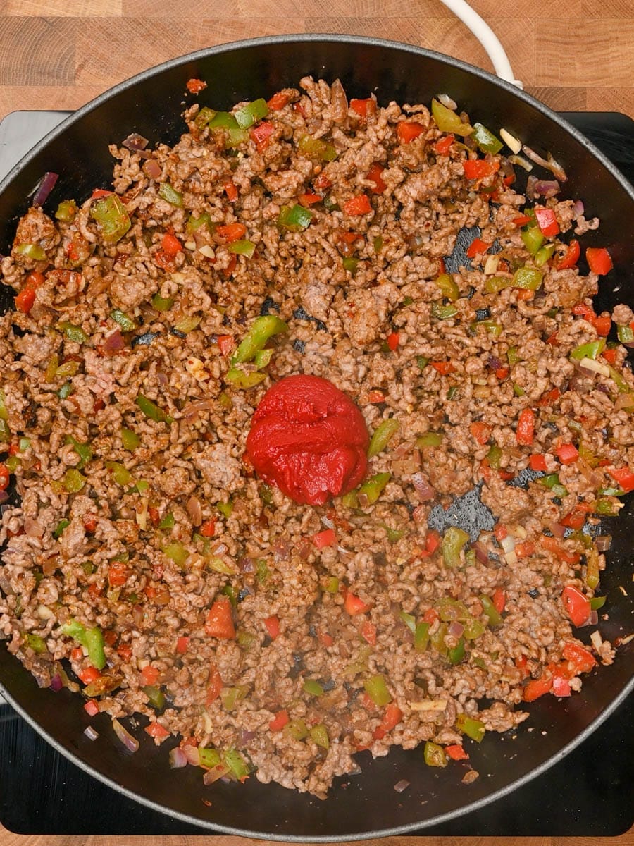 Adding tomato paste to cooked ground beef
