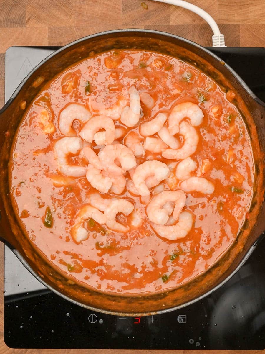 adding prawns to an Indian dish