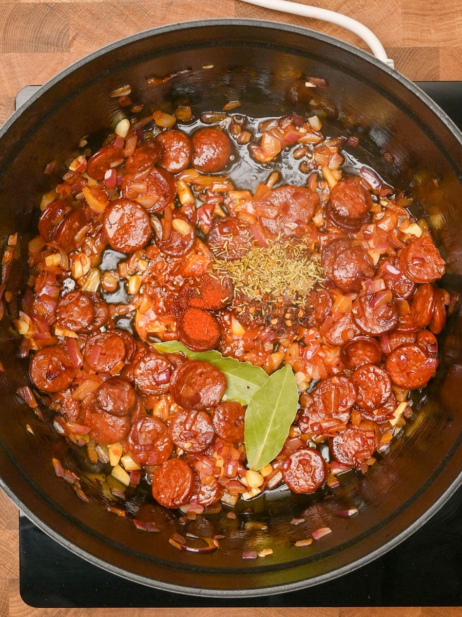 adding spices to a Chickpea and Chorizo Stew