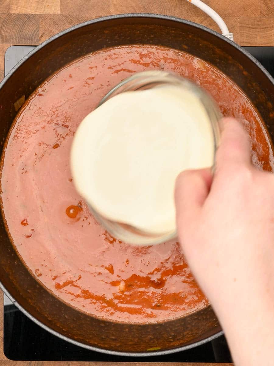 adding cream to a Mediterranean dish