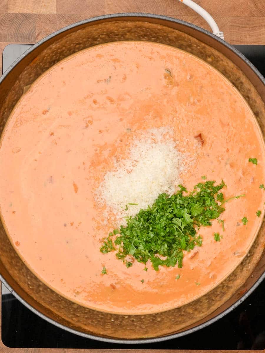 adding parmesan to a Mediterranean dish
