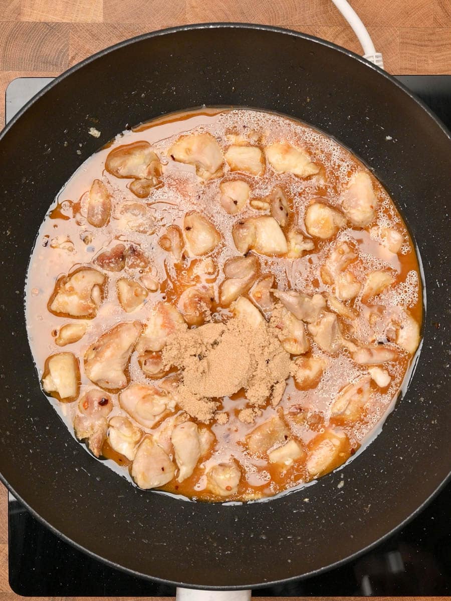 adding sugar to an Asian dish