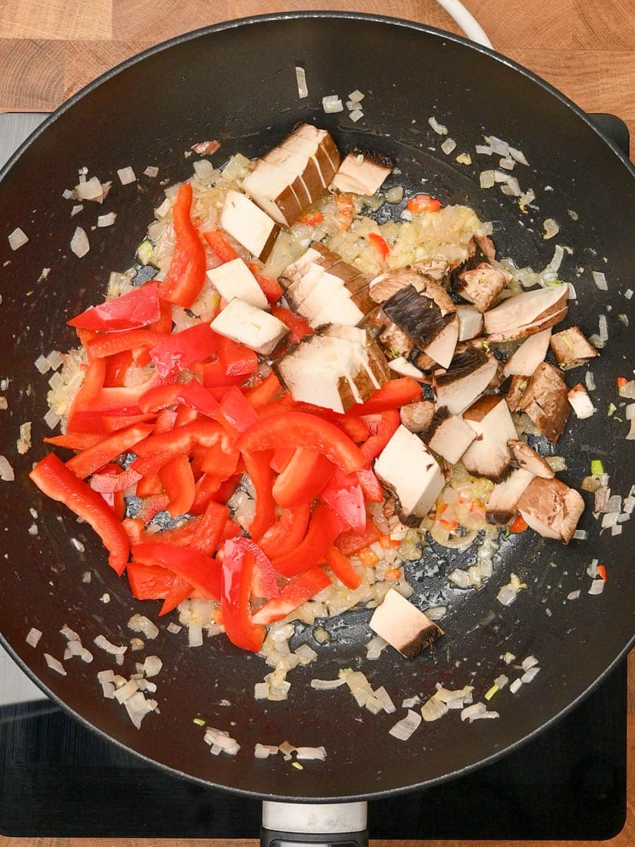 adding mushrooms to a Ground Pork Stir Fry