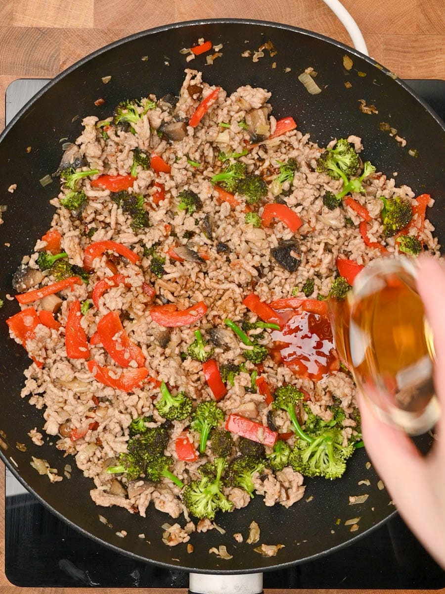 adding sauces to a Chinese dish