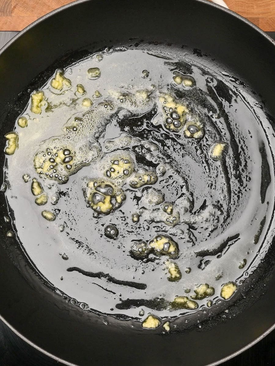adding garlic to an American dish