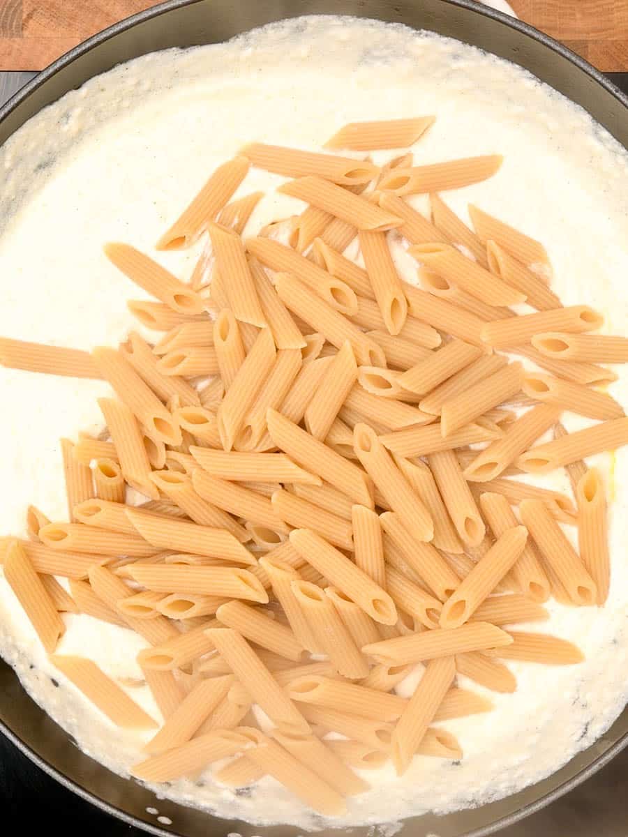 adding pasta to an American dish
