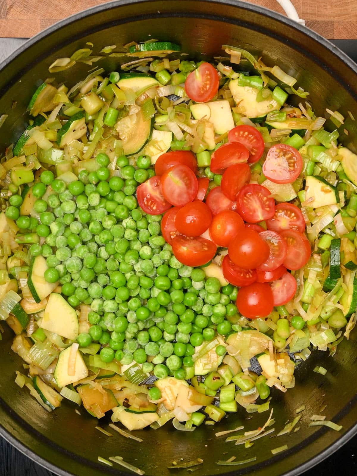 adding tomatoes to Chicken Pasta Primavera