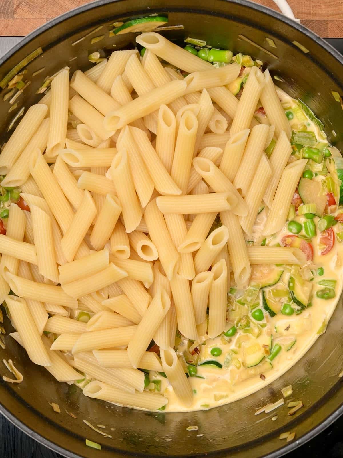 adding penne to the pot