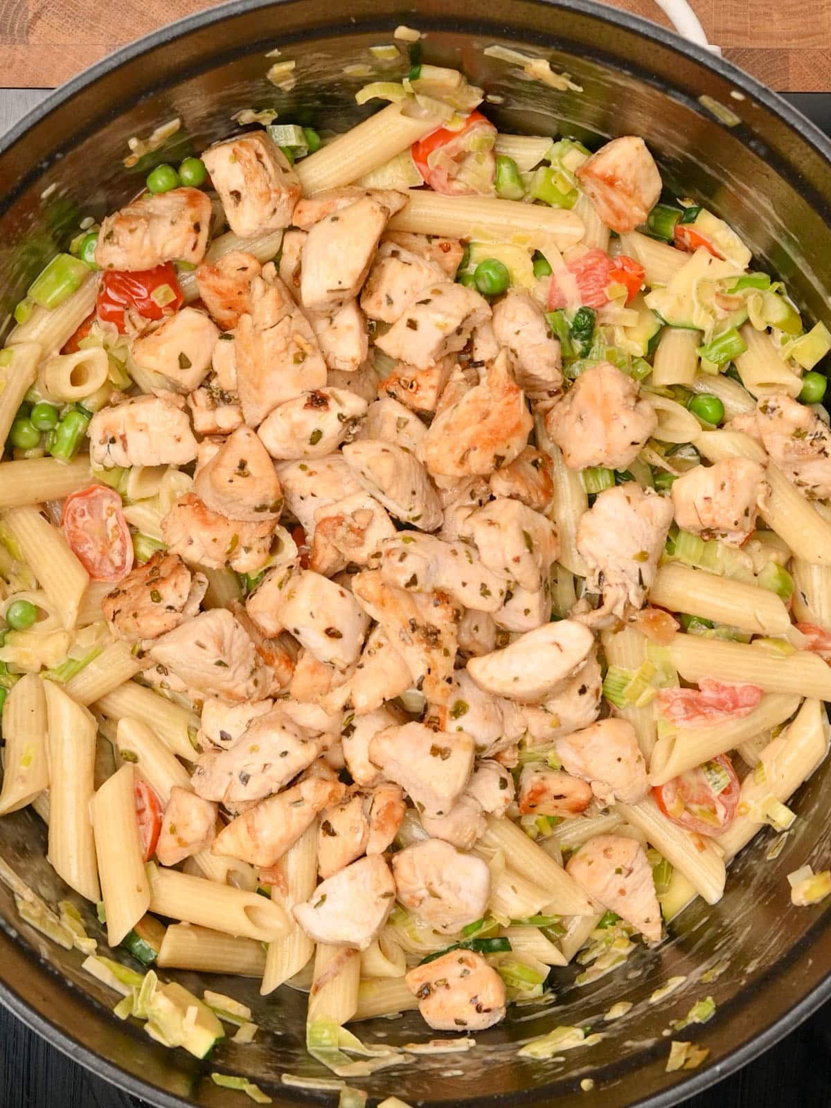 adding cooked chicken to the pot