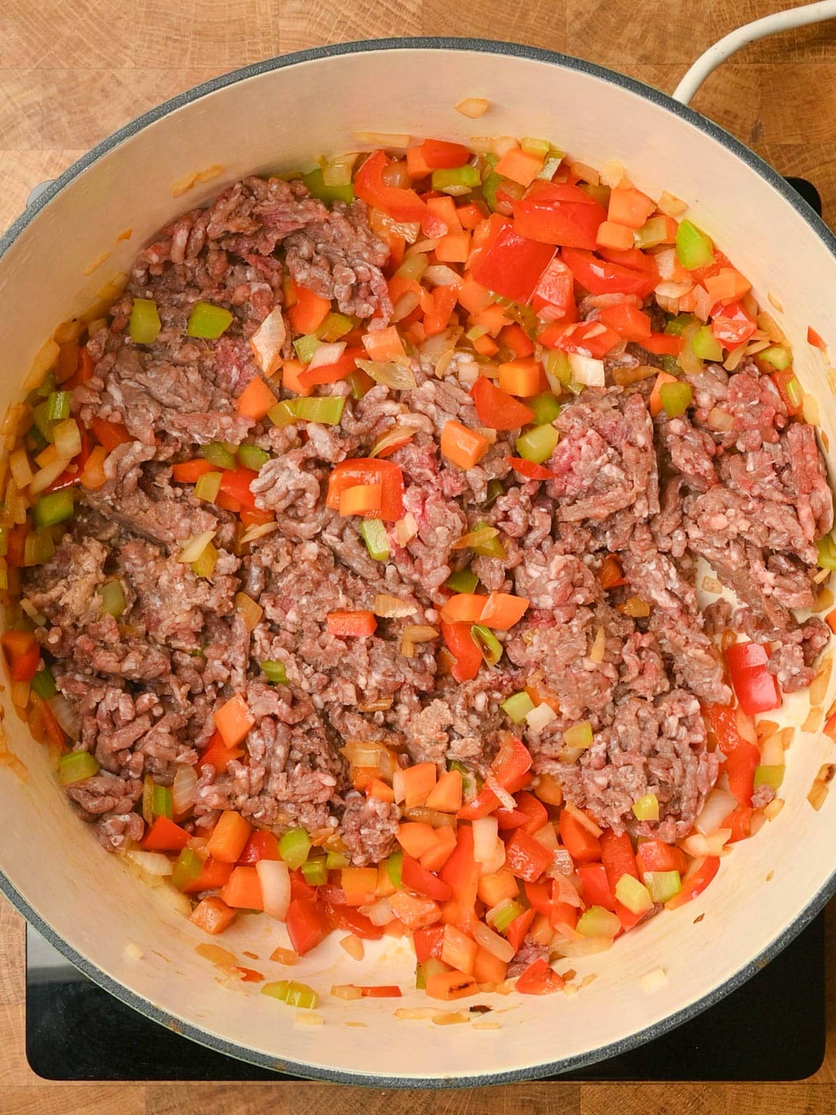 adding ground beef to the pot