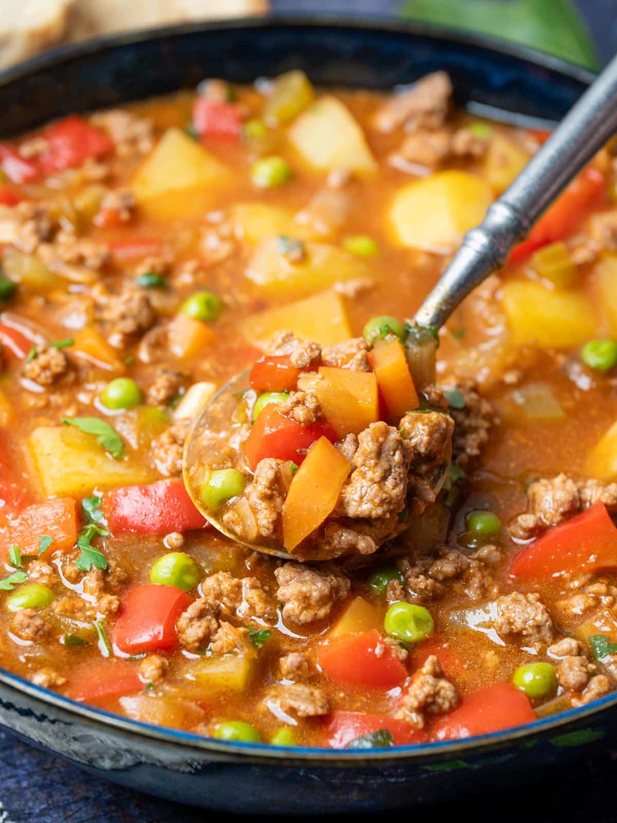 Close up photo of a ground beef stew with a spoon showcasing it