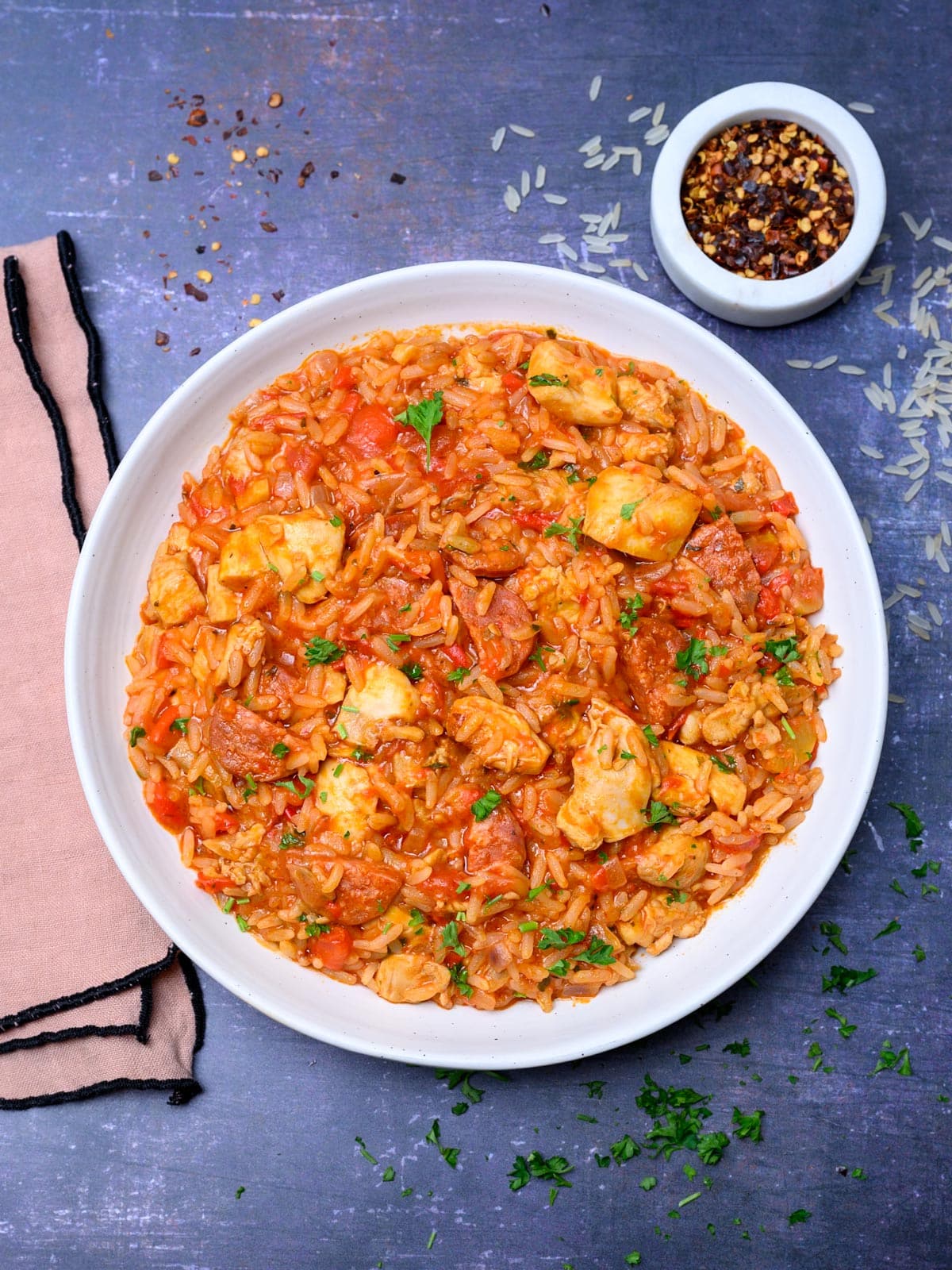 chicken and chorizo rice with chilli flakes on the side