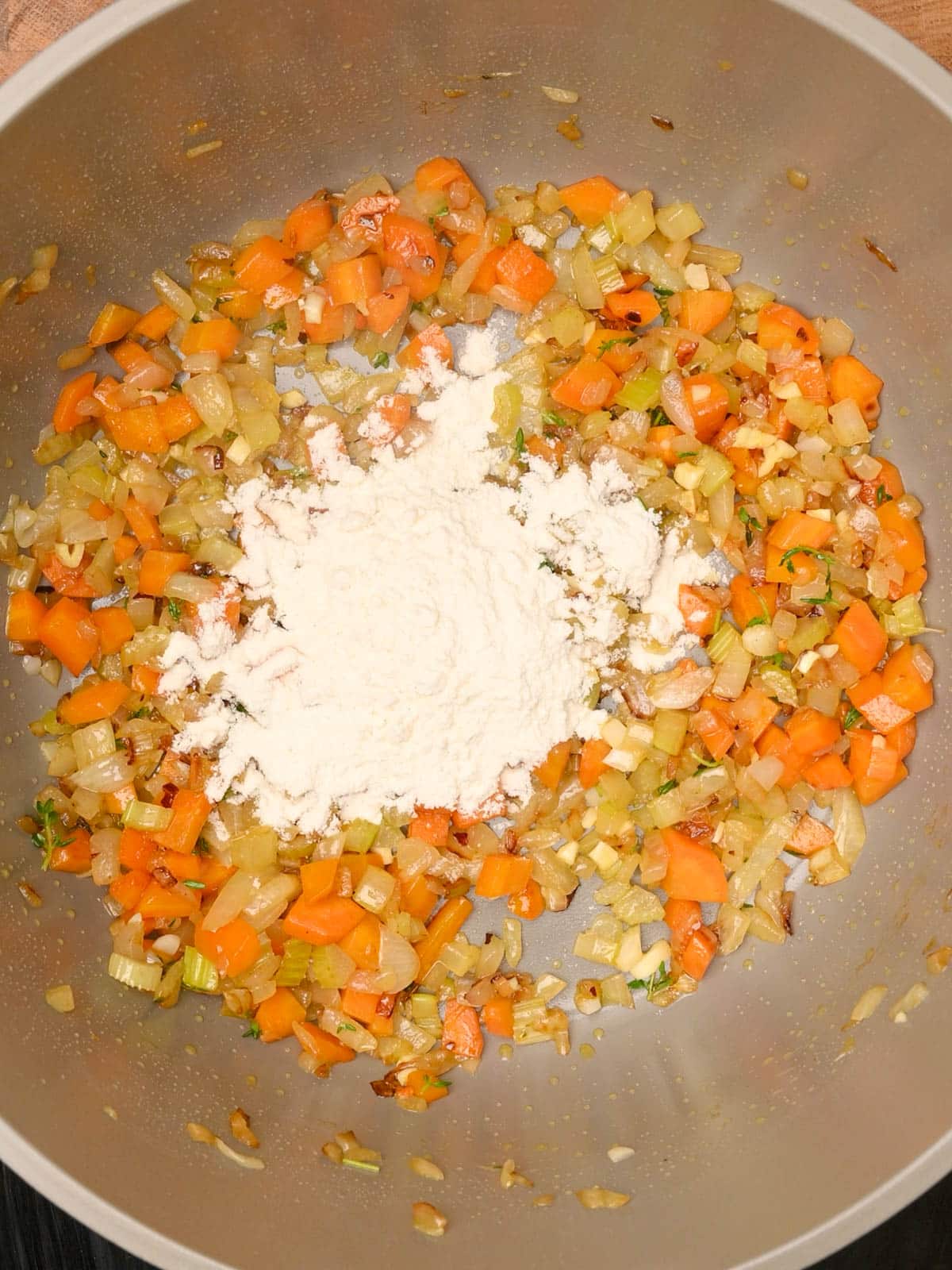 adding flour to a bacon potato soup
