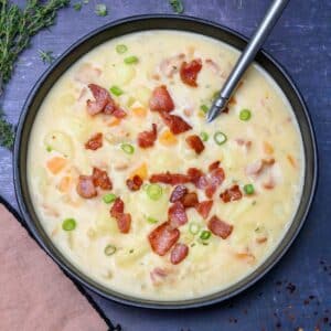 a bowl of soup with spring onion on top