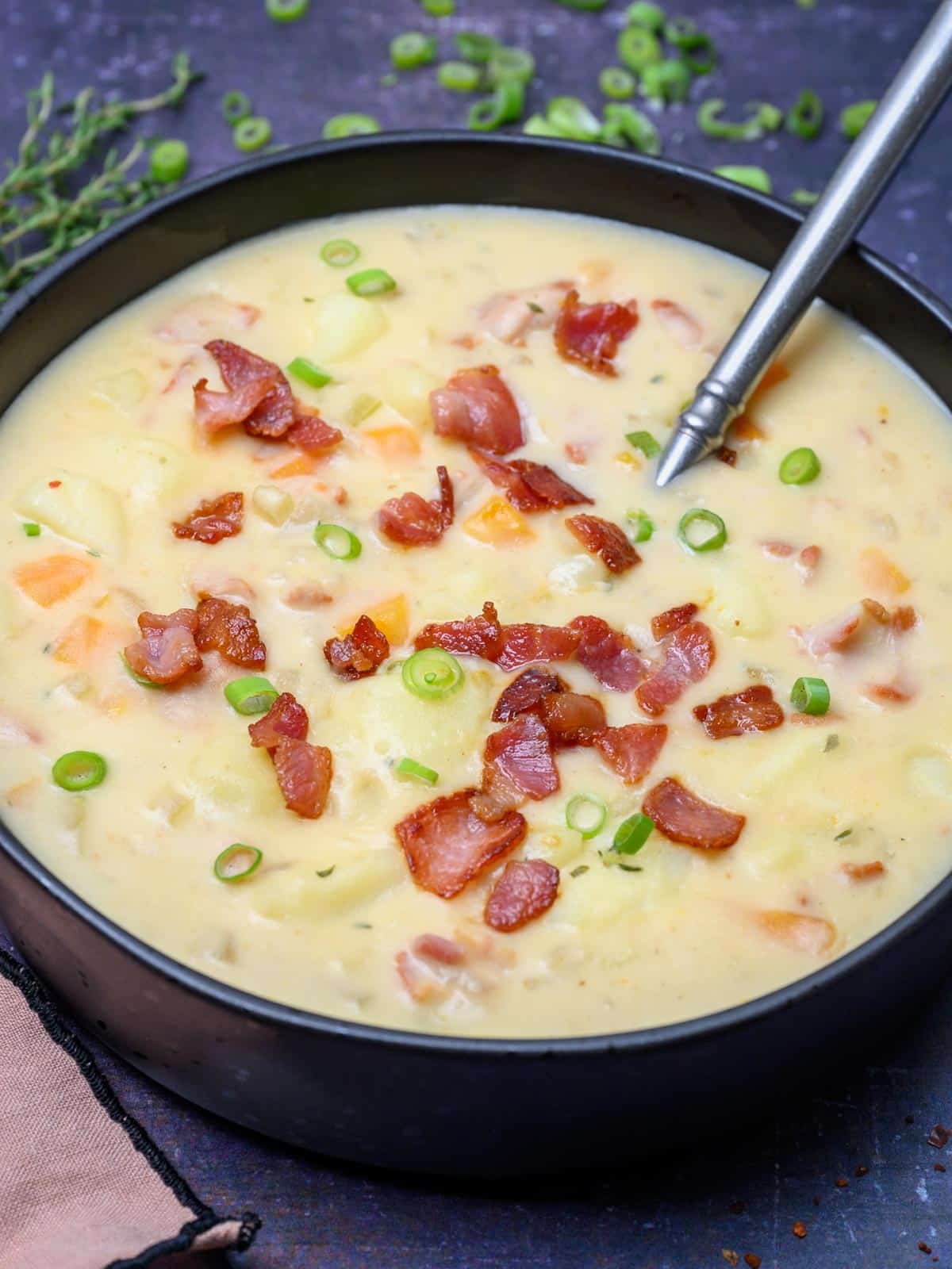 close up photo of a black bowl of soup