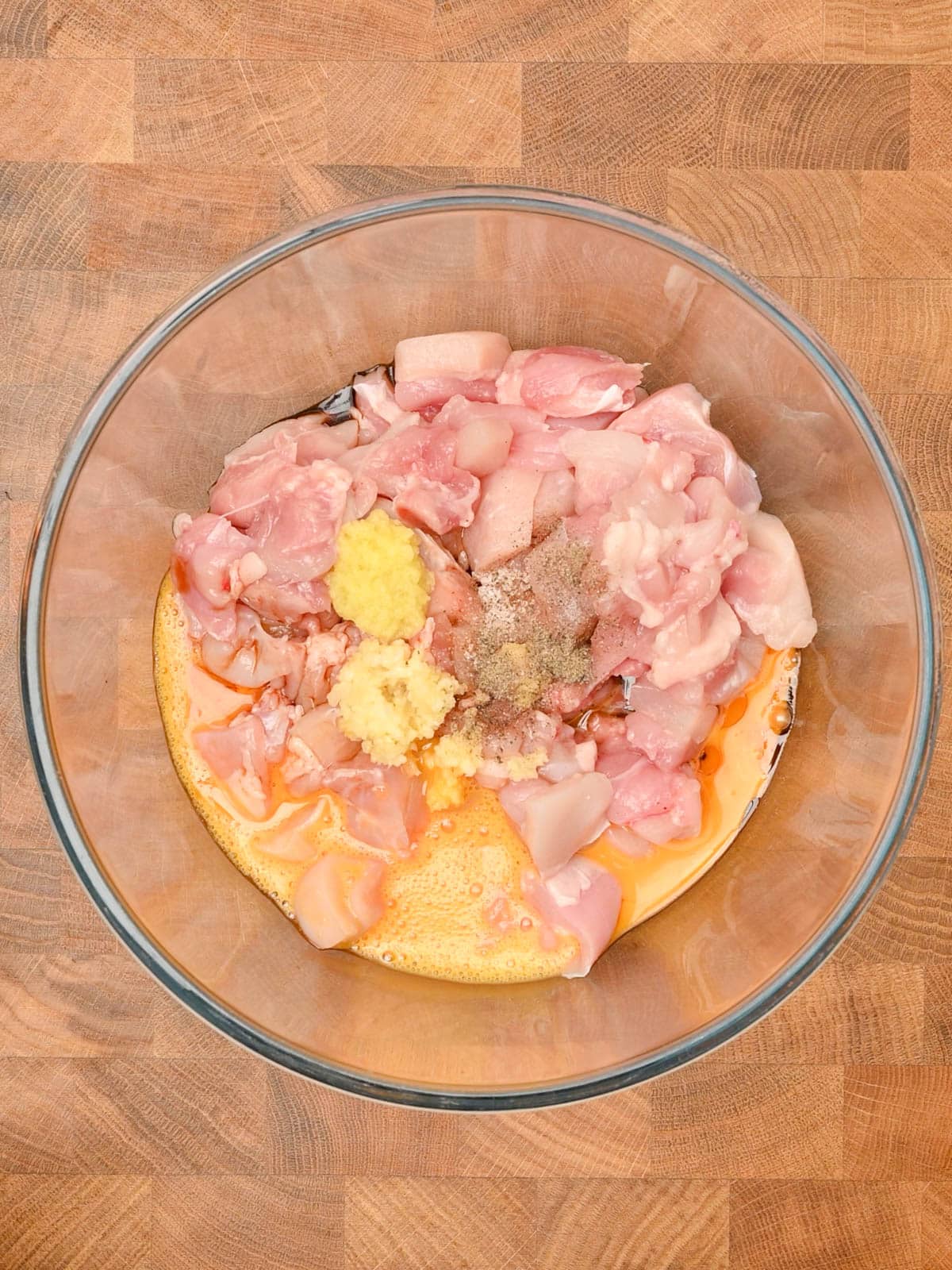 adding garlic and ginger to a bowl to make bang bang chicken