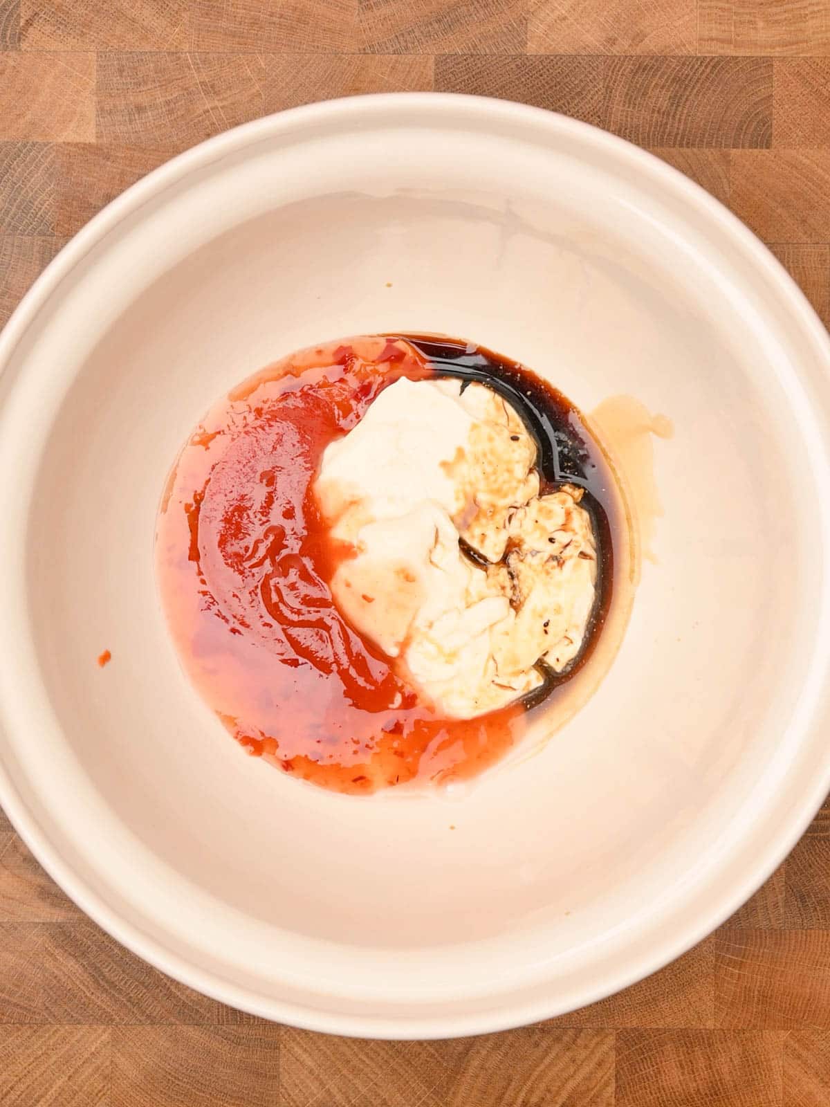 mayonnaise, sweet chilli and soy sauce in a white bowl